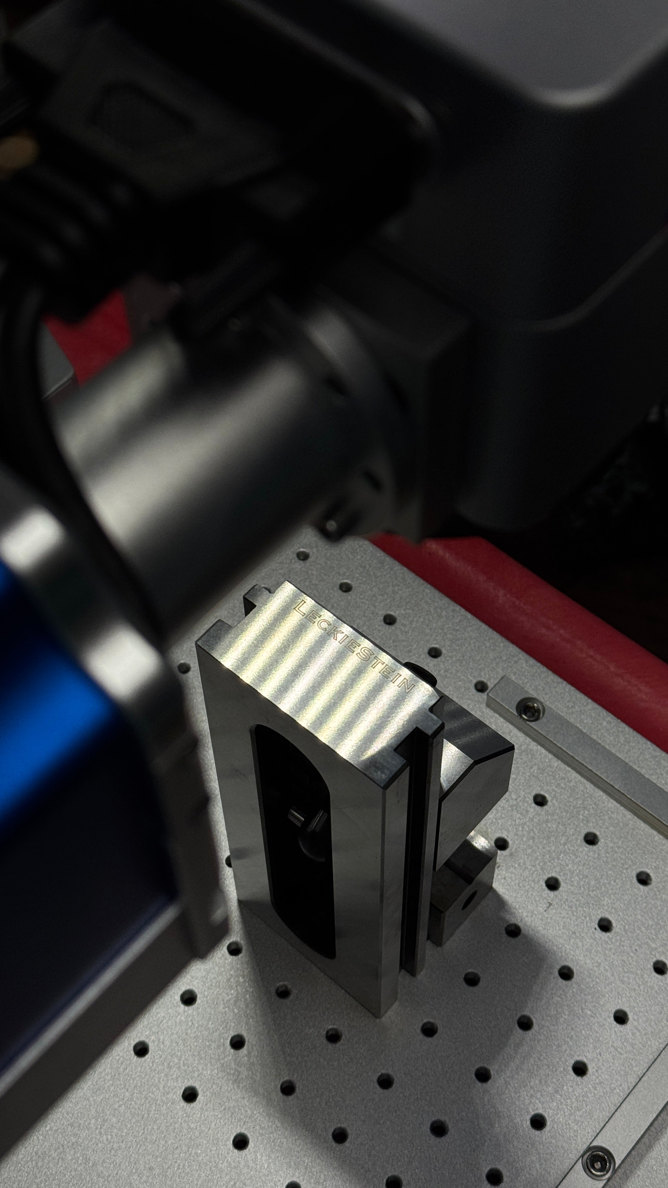 Close-up of a mechanical component on a pegboard with blurred background