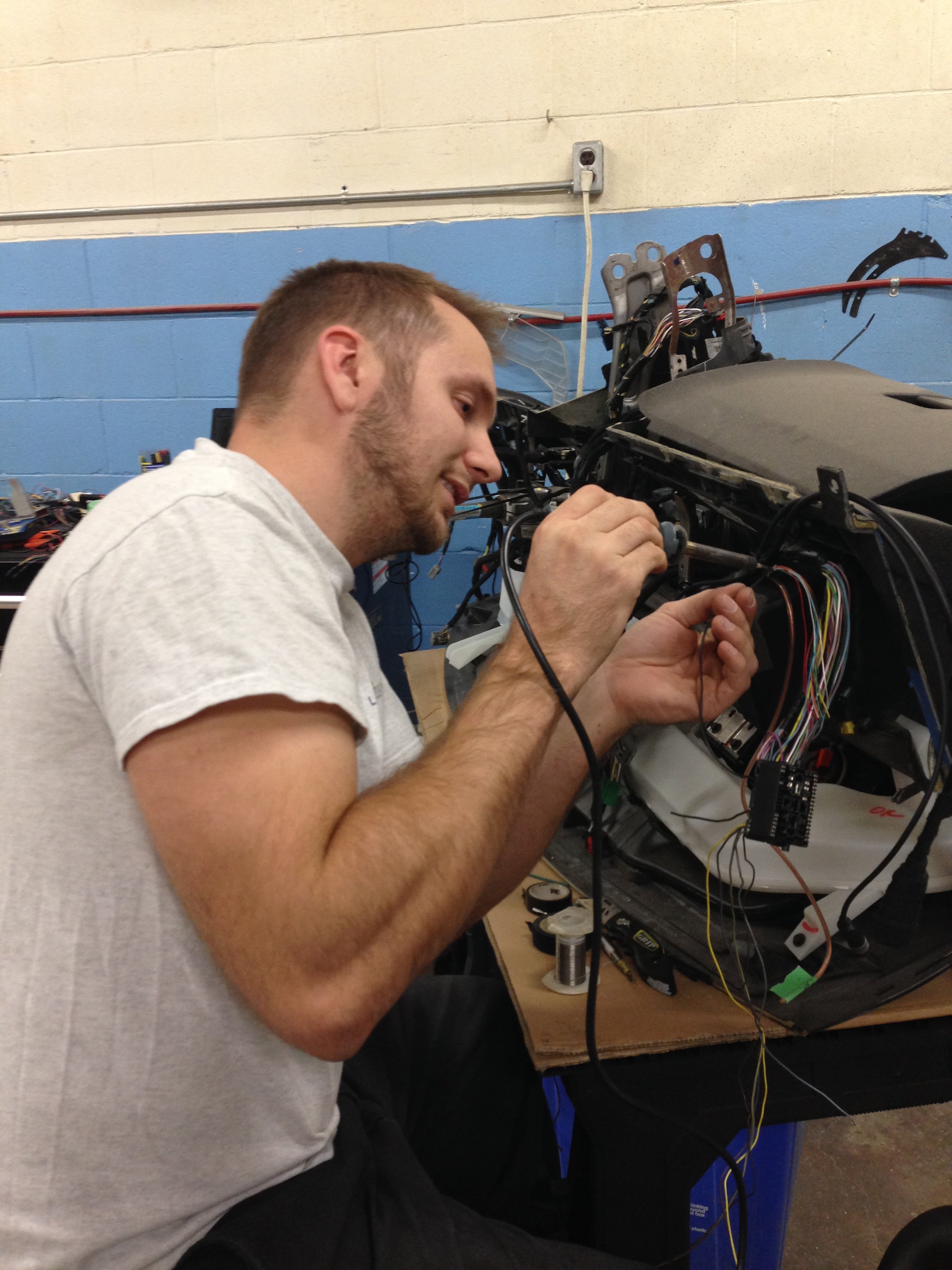Person working on electronic equipment with a blue sky background